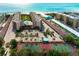 Beautiful aerial view of condo complex with beach access, tennis courts, swimming pool and well-maintained grounds at 6480 Midnight Pass Rd # 315, Sarasota, FL 34242