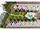 Aerial shot of beach condos with tropical landscaping and a community pool in a courtyard setting at 6480 Midnight Pass Rd # 315, Sarasota, FL 34242