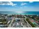 Aerial of a beach community with businesses and beachfront condos along the coast at 6480 Midnight Pass Rd # 315, Sarasota, FL 34242
