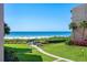 View from unit overlooking backyard, sandy beach, and the Gulf of Mexico at 6480 Midnight Pass Rd # 315, Sarasota, FL 34242