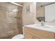 Bathroom featuring tile shower with glass doors and light wood vanity with white sink at 6480 Midnight Pass Rd # 315, Sarasota, FL 34242