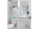 Bright bathroom featuring a white vanity, toilet, and a shelf with towels and toiletries at 6480 Midnight Pass Rd # 315, Sarasota, FL 34242