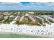 Picture of beachfront condos with a lush green courtyard, landscaping, and a gorgeous white sand beach at 6480 Midnight Pass Rd # 315, Sarasota, FL 34242