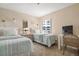 Cozy bedroom with twin beds, soft lighting, and a window offering a glimpse of the outdoors at 6480 Midnight Pass Rd # 315, Sarasota, FL 34242