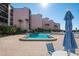 Relaxing community pool with lounge chairs and umbrellas for enjoying the sunny weather at 6480 Midnight Pass Rd # 315, Sarasota, FL 34242