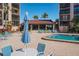 Beautiful community pool area with comfortable seating options and a building with glass windows at 6480 Midnight Pass Rd # 315, Sarasota, FL 34242
