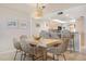 Dining area features large table with seating and access to the kitchen at 6480 Midnight Pass Rd # 315, Sarasota, FL 34242