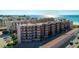Exterior view of a beachfront condo building with multiple floors and balconies offering stunning ocean views at 6480 Midnight Pass Rd # 315, Sarasota, FL 34242