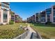 Beautiful exterior view of the residences with manicured grounds, walkway and lush landscaping at 6480 Midnight Pass Rd # 315, Sarasota, FL 34242