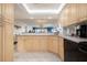 Bright and functional kitchen with wood cabinets and a view into the living space, promoting an open atmosphere at 6480 Midnight Pass Rd # 315, Sarasota, FL 34242