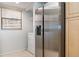 Convenient laundry area with stainless steel refrigerator and side-by-side washer and dryer setup by a window at 6480 Midnight Pass Rd # 315, Sarasota, FL 34242