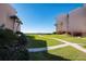 Well-manicured lawn with path leading to the beach and ocean views, surrounded by lush landscaping at 6480 Midnight Pass Rd # 315, Sarasota, FL 34242