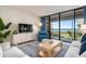 Bright living room with balcony access offering views of the beach and property at 6480 Midnight Pass Rd # 315, Sarasota, FL 34242