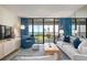 Living room area with cozy seating, beach views, and a sliding glass door to the balcony at 6480 Midnight Pass Rd # 315, Sarasota, FL 34242
