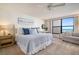 Comfortable bedroom with beach decor, a ceiling fan, and ocean view, perfect for relaxation and serene living at 6480 Midnight Pass Rd # 315, Sarasota, FL 34242