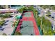 Aerial view of the property's tennis courts and surrounding landscape with palm trees and greenery at 6480 Midnight Pass Rd # 315, Sarasota, FL 34242