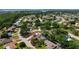 Aerial view of a residential neighborhood featuring a screened-in pool and lush greenery at 6604 23Rd W Ave, Bradenton, FL 34209