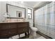 Bathroom featuring a vanity, commode, and tub with blue-and-white striped shower curtain at 6604 23Rd W Ave, Bradenton, FL 34209