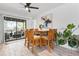 Bright dining room featuring a ceiling fan, art, and sliding glass doors to the outdoor patio at 6604 23Rd W Ave, Bradenton, FL 34209