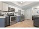 Kitchen featuring stainless steel appliances and white and gray cabinets at 6604 23Rd W Ave, Bradenton, FL 34209