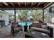 Screened lanai featuring an outdoor seating area with view to the pool and landscaped backyard at 6604 23Rd W Ave, Bradenton, FL 34209