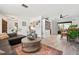 Open-concept living space with stylish decor, flowing seamlessly to a dining area and outdoor access at 6604 23Rd W Ave, Bradenton, FL 34209