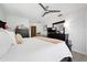 Bright main bedroom features a queen bed, ceiling fan, and a black dresser at 6604 23Rd W Ave, Bradenton, FL 34209