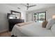 Bright main bedroom featuring dresser, view to the pool, ceiling fan, and a queen bed at 6604 23Rd W Ave, Bradenton, FL 34209