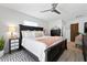 Bright main bedroom features a queen bed, ceiling fan, and a gray dresser at 6604 23Rd W Ave, Bradenton, FL 34209