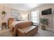 Comfortable main bedroom featuring a queen bed, a window, and mounted television at 6604 23Rd W Ave, Bradenton, FL 34209