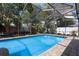 Sparkling screened-in pool with brick pavers and ample space for outdoor entertaining at 6604 23Rd W Ave, Bradenton, FL 34209