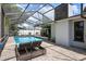 Attractive screened-in pool area featuring lounge chairs and a spacious brick patio for relaxation at 6604 23Rd W Ave, Bradenton, FL 34209