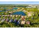 Aerial view of a home in a lush community with lakes and picturesque scenery, pinpointed for location at 7016 Lennox Pl, University Park, FL 34201
