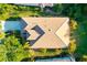 Aerial shot of the home showing the roof and surrounding lush landscaping at 7016 Lennox Pl, University Park, FL 34201