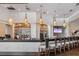Modern bar area featuring pendant lighting, ample seating, and a well-stocked liquor display at 7016 Lennox Pl, University Park, FL 34201