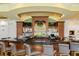Well-appointed bar featuring dark countertops, wooden accents, and comfortable seating at 7016 Lennox Pl, University Park, FL 34201