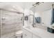 Bright bathroom features a walk-in shower, white vanity and modern fixtures at 7016 Lennox Pl, University Park, FL 34201