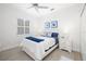 Bright bedroom features wood floors, a ceiling fan, and shutters at 7016 Lennox Pl, University Park, FL 34201