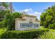 Elegant entrance sign for University Park Country Club, surrounded by lush greenery and landscaping at 7016 Lennox Pl, University Park, FL 34201