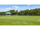 Lush green croquet field with covered seating areas, providing a perfect recreational space at 7016 Lennox Pl, University Park, FL 34201