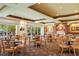 Bright dining space with tables, chairs, large windows, and a cozy fireplace at 7016 Lennox Pl, University Park, FL 34201