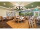 Inviting dining area with charming decor, ample seating, and a light fixture above at 7016 Lennox Pl, University Park, FL 34201