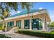 Attractive building with a blue tile roof, large windows, and landscaped surroundings at 7016 Lennox Pl, University Park, FL 34201