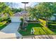 Beautifully landscaped home featuring a well-manicured lawn and a spacious driveway, perfect for suburban living at 7016 Lennox Pl, University Park, FL 34201