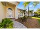 Inviting front entrance with manicured landscaping, a charming walkway, and a bright, welcoming facade at 7016 Lennox Pl, University Park, FL 34201