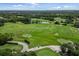 Expansive aerial view of the lush golf course surrounded by serene lakes and upscale residential homes at 7016 Lennox Pl, University Park, FL 34201