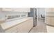 Kitchen features stainless steel refrigerator, window and plenty of cabinet space at 7016 Lennox Pl, University Park, FL 34201
