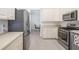 Spacious kitchen with stainless steel appliances and abundant cabinet space at 7016 Lennox Pl, University Park, FL 34201