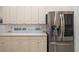 Bright kitchen features stainless steel refrigerator and plenty of cabinet space at 7016 Lennox Pl, University Park, FL 34201