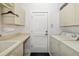 Efficient laundry room with plenty of storage space and a utility sink at 7016 Lennox Pl, University Park, FL 34201